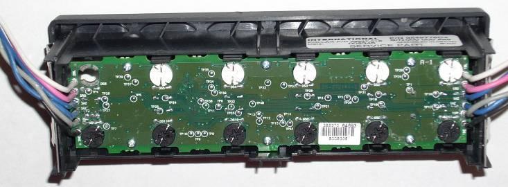 The top portion of the switchpack can be identified by looking on the back of the switchpack and noting where the white wire is coming out of the circuit board.