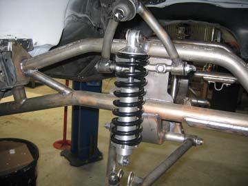 Install the shock to the upper mount using the supplied ½ -20 by 1 ¾ inch button head bolt and ½ -20 half height nut.