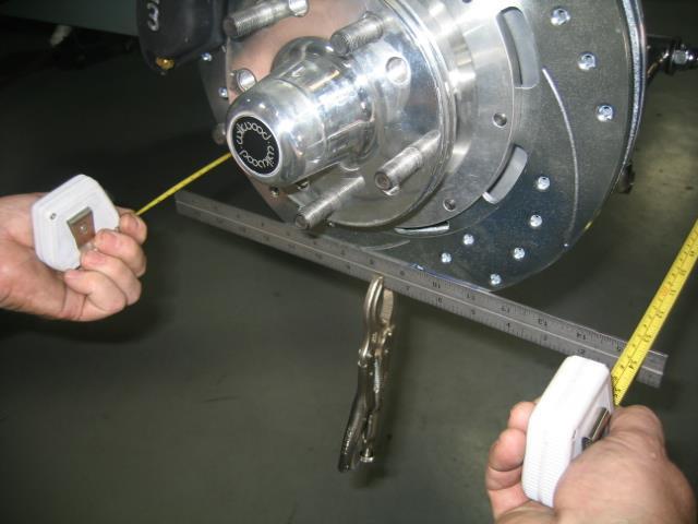 Clamp a straight edge to each rotor as shown then using a tape measure front and rear; set the toe-in