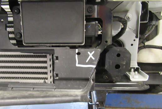 11. Using a utility knife remove the indicated area on the driver side of the