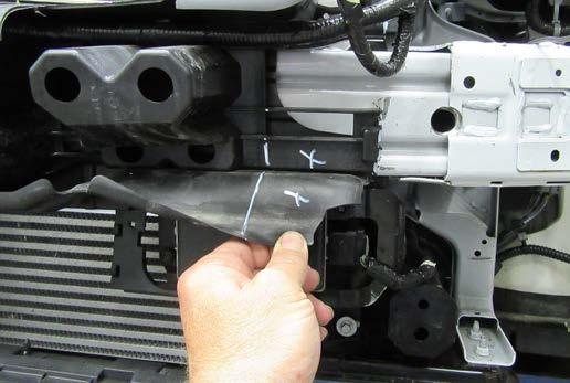 Using a utility knife remove the indicated areas on the passenger side of the