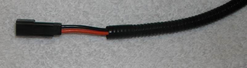 Figure 8: 12V power point connector. 11. Unplug the tail lights and indicator lights from the tail light harness.