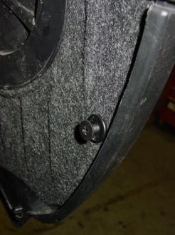 The next fasteners to be removed are those that secure the wheel arch liner at