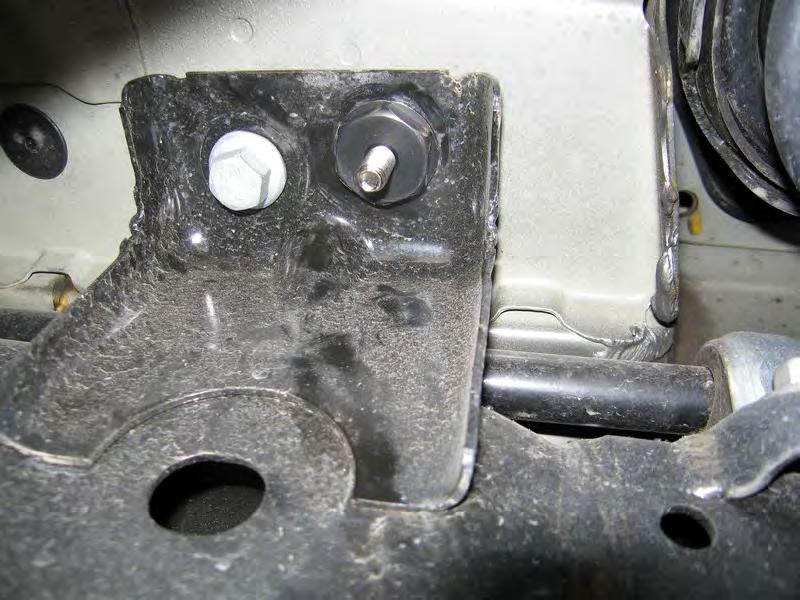 (Refer to Step #2) Disassemble the attachment hardware and slide the rectangular part into the holes closest to the rear springs. Center it in the hole and screw the black nut as shown in the images.