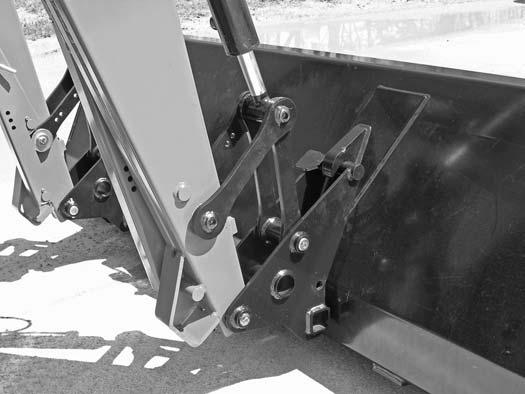 Dismount the tractor. Move the attachment coupler handle to the locked (closed) position. The lockpins must be completely extended and secured into the retaining slots, Figure 7.