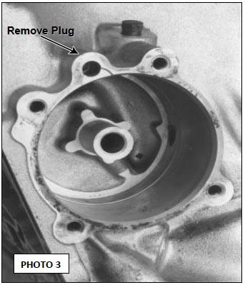 We have marked (PHOTO 3) to show location on the case where an 1/8 Allen head plug was in- stalled for the Full Manual Valve Body. (See PHOTO 3) Remove this plug.