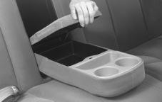 In front of the storage area is a cupholder. Press and release the cupholder cover to open. Do not try to pull it out.
