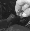 2. Remove the air intake hose that is fitted over the throttle body by pulling the hose upward and away from the throttle body which is located near the top of the engine. 3.