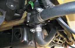 149. Route the elbow hose from the lower barb of the reservoir down to inlet of the coolant pump.