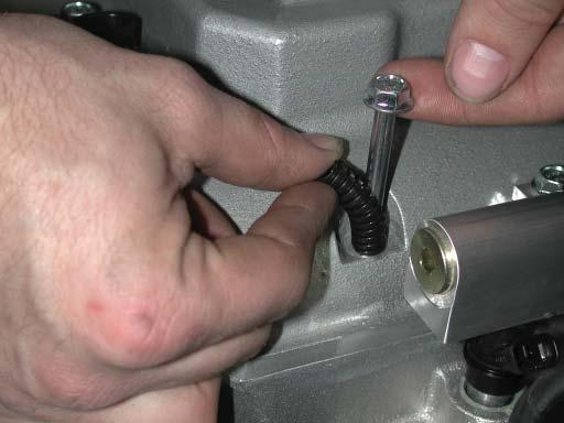 65. Using an assistant, carefully lower manifold assembly into place, be