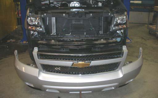 With the help of an assistant, carefully remove the front fascia and set aside where it