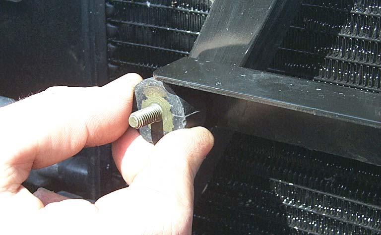 133. Remove the stock cross member bolts from the radiator