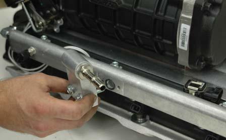 Install the assembled fuel manifold to the driver side fuel rail using the two new supplied