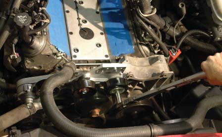 128. Install the new tensioner support bracket in the original tensioner location.