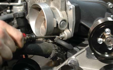 Attach the other end to the barb on the bottom of the throttle body with