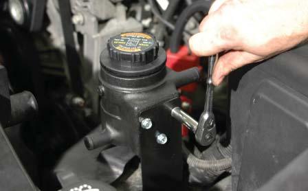 216. Mount the intercooler reservoir bottle to the mounting bracket installed in step #197 using the