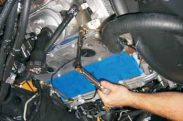 Using a file or die grinder, remove material from the alternator mounting bracket marked in the