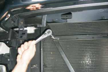 140. Remove the stock cross member bolts from the radiator brace bolt