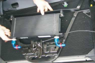 Mount the intercooler assembly to the radiator brace by placing the