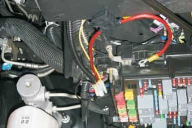 Cover the red and black wires that lead to the intercooler coolant pump connector with the split loom supplied.