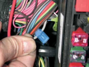 160. In the wiring below the fuse/relay center, locate the gray fuel pump wire that goes from the relay
