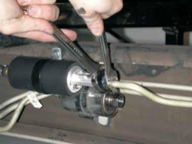 While supporting the pump using backup 7/8 wrench, tighten fuel line
