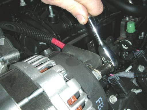 33. Using a 10mm socket wrench, remove the nut holding the positive (+) wire to the