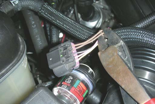 Using the crimp/shrink connectors supplied, connect one white wire to the tan wire and the other white wire to the tan wire with black stripe that runs to the vehicles