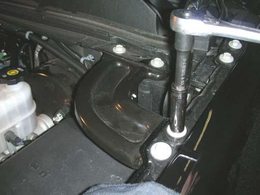 113. Remove the driver side fender to fi rewall brace with a 13mm socket wrench,