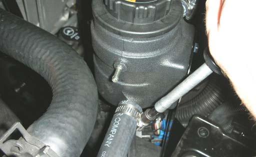 Route the hose through the radiator support and under the intercooler pump, trim to fi t and connect it to the