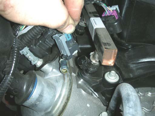 Unplug the eight fuel injector plugs by pulling up on the gray tab and then pushing in