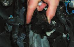Remove the Purge solenoid and EVAP line by pulling the solenoid free from its mounting location on the left