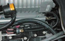 Attach a short length of hose to the right intercooler manifold barb temporarily and route it to the mouth of the funnel as shown.
