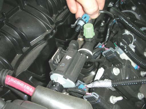 25. With the wiring harness out of the way, unplug the EVAP electrical connector from the solenoid. 26.