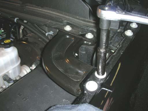 Remove the driver side fender to fi rewall brace with a 13mm socket wrench, to gain access to the fuse