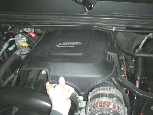 Remove the plastic engine cover by lifting up at the