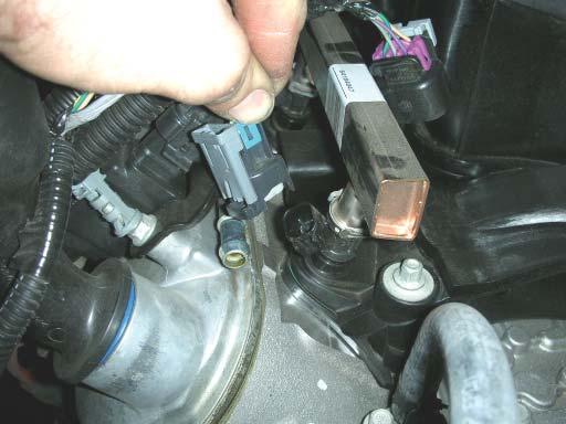 Unplug the eight fuel injector plugs by pulling up on the gray tab and then pushing in on the