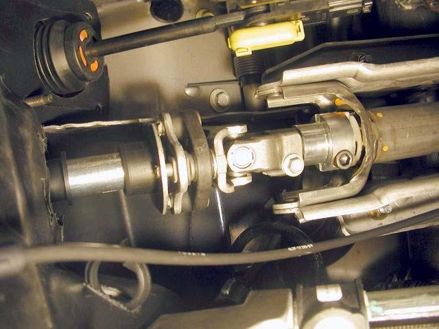 2. Slide the steering U-joint onto the kit steering extension. 3. Ensure the steering wheel has not turned. Tighten the bolt to 33 lb-ft. 4.