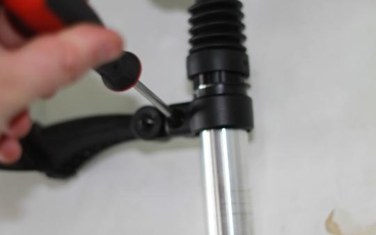 Tighten the mudguard to the seat post using a phillips head screwdriver.