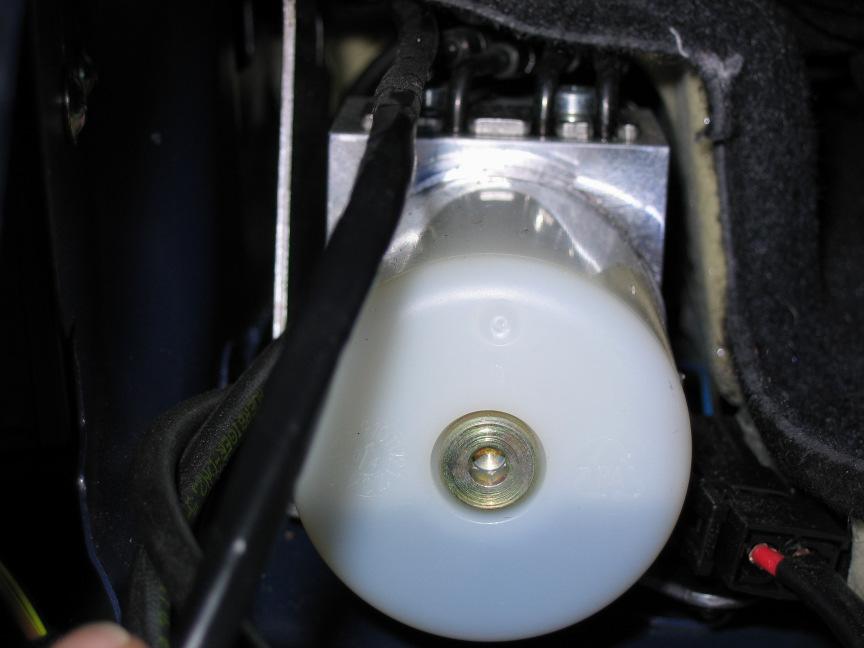 With the light removed, look to the forward part of the light opening, you will find a wiring harness running on top of or next to the power roof control assembly (Photo 3).