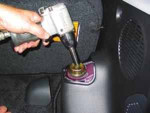 Remove the section of interior trim blocking access to the upper shock mount (Figure 1). NOTE: This is located behind the seats in the trunk compartment above the strut pocket. Figure 3 2.