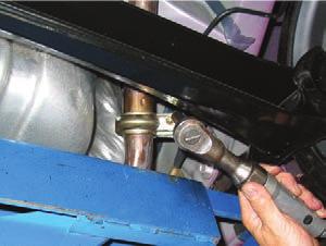 Using a pry bar, remove the rubber hangers from the muffler