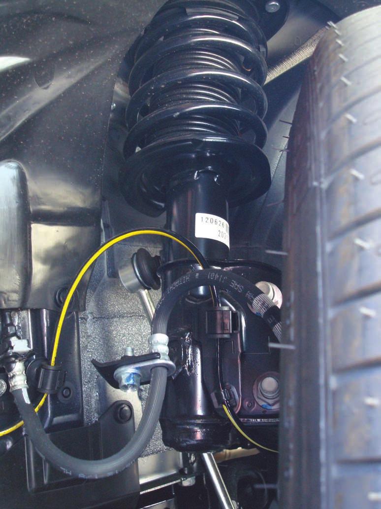 Remove the bolts retaining the brake hose and unclip the ABS sensor wire (Fig. 2). Brake line bolt ABS sensor wire fig.