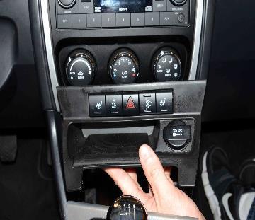 If equipped with a manual transmission, using trim stick C-4755 or equivalent, pry up on the shifter boot bezel and position the bezel to the side.