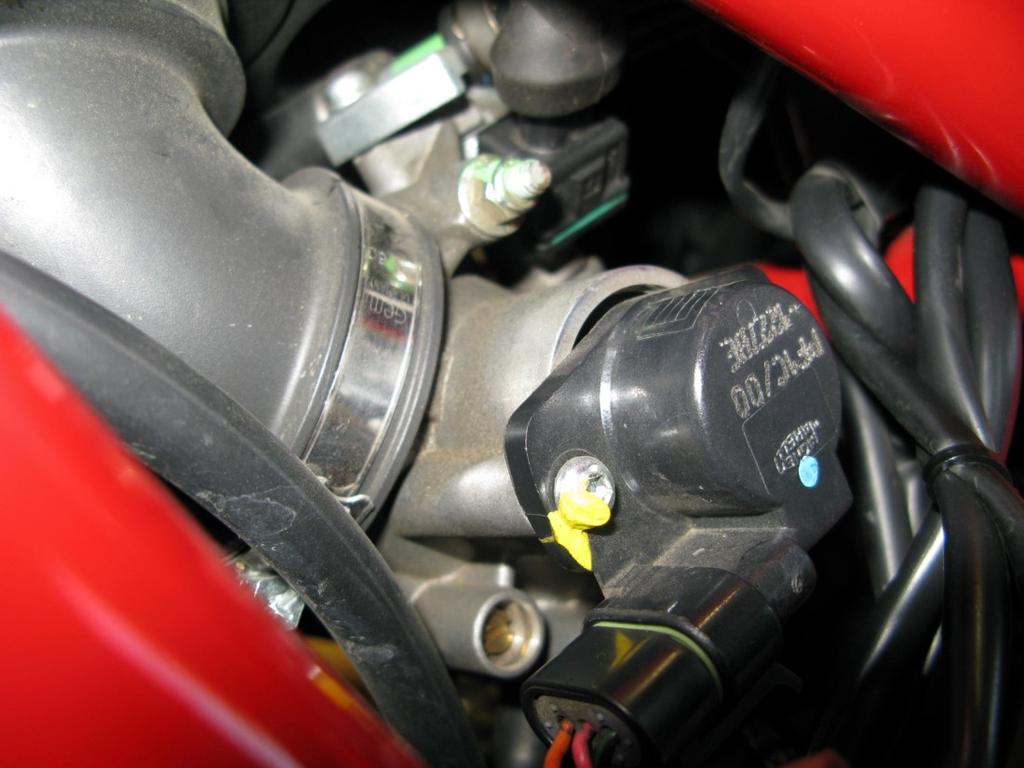 6. Locate the injector for the rear cylinder, found on the left side of the throttle bodies just inside