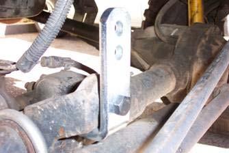 Prepare to Install Front Suspension holes at the top. Secure using the 1/2 x 2 bolt and hardware. Tighten the bracket into place.
