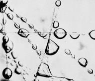 Water coalescing initiates by water droplets impacting with a hydrophilic fiber matrix within the Coalescer.