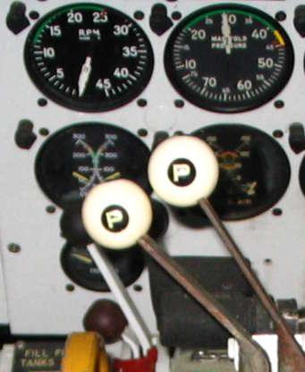 Propeller Levers FEATHERING SYSTEM Feathering Controls Two red buttons are mounted on the overhead panel for operating the propeller feathering systems.