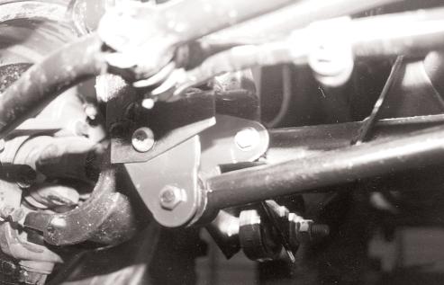 7. Locate the front track bar mount on the axle, insert new bracket (see photo #7). Insert original bolt and keeper nut through original hole.
