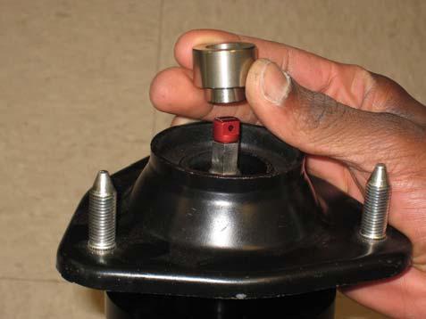 Note: Be sure to use a spring compressor before removing the OE strut rod nut or serious